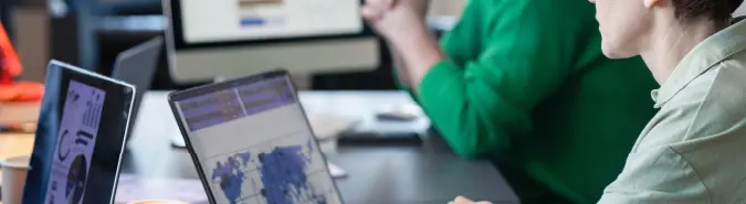 Team collaborating over laptops with network data visualizations, illustrating Exigo Tech's Secure Access Service Edge (SASE) solutions in Australia for enhanced security and optimized networking Team collaborating over laptops with network data visualizations, illustrating Exigo Tech's Secure Access Service Edge (SASE) solutions in Australia for enhanced security and optimized networking