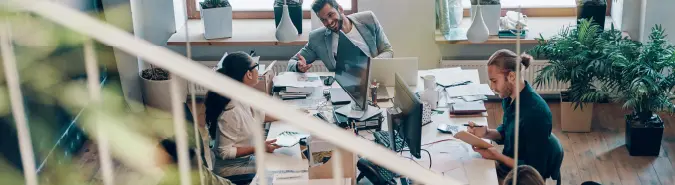 Team working in a collaborative office environment, representing Exigo Tech's DevOps delivery model in Australia for streamlined software development and deployment Team working in a collaborative office environment, representing Exigo Tech's DevOps delivery model in Australia for streamlined software development and deployment