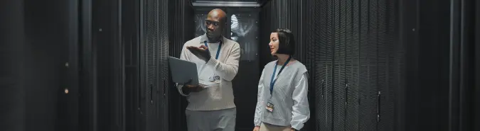 Two professionals discussing compute services in a data center environment, highlighting cloud and hybrid IT infrastructure solutions by Exigo Tech