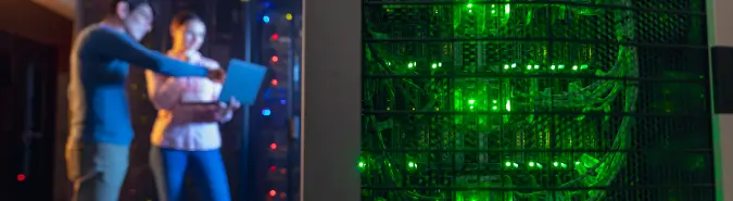 Technical experts reviewing server virtualisation setups in a server room, emphasizing virtualization platforms like VMware and Hyper-V by Exigo Tech