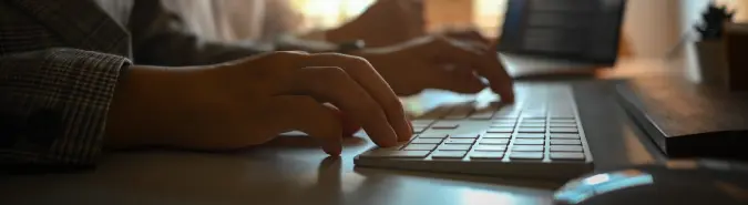 Close-up of hands on a keyboard, representing Azure Integration Services for hybrid cloud and on-premises workflows by Exigo Tech