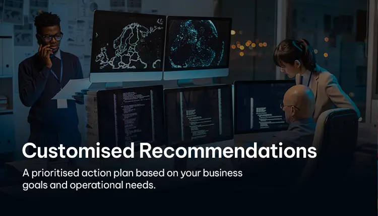 Professionals discussing customized cybersecurity recommendations with multiple monitors Professionals discussing customized cybersecurity recommendations with multiple monitors