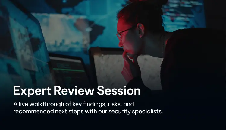 Security specialist reviewing data and findings on multiple monitors during an expert session Security specialist reviewing data and findings on multiple monitors during an expert session
